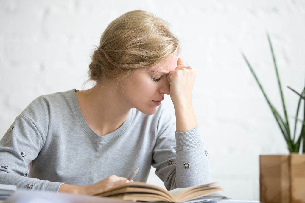 woman suffering from vertigo after reading a book
