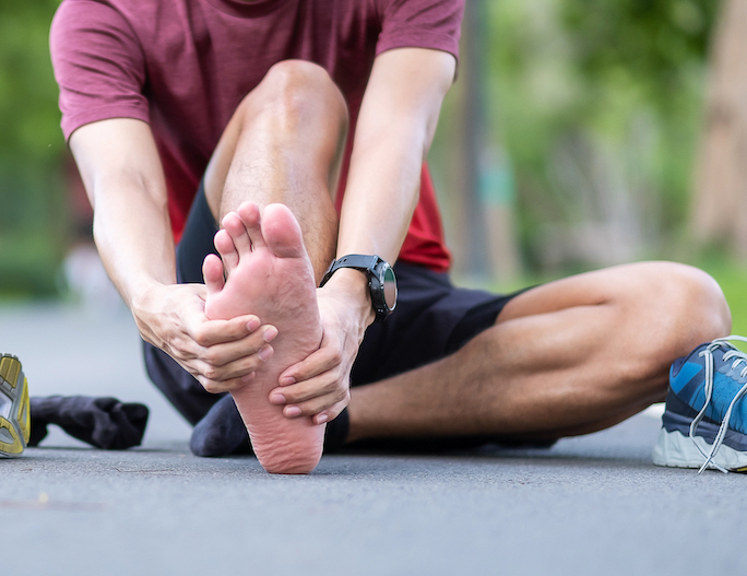 man suffering from plantar fasciitis after walking