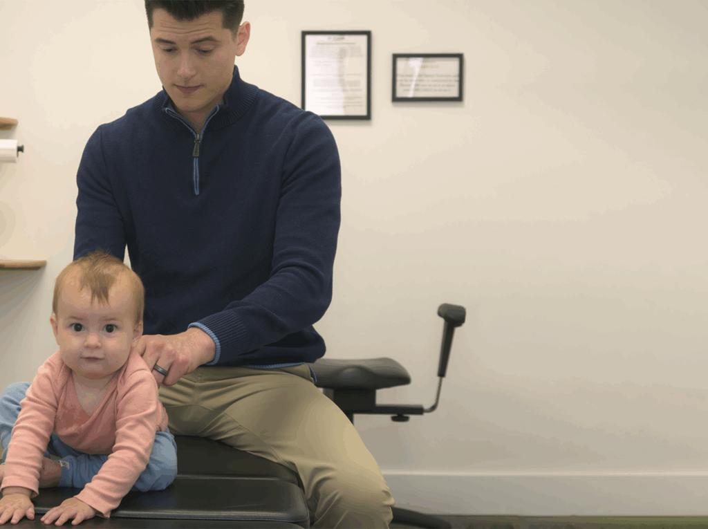 Dr. Matthew Wittwer giving a baby girl pediatric care treatment